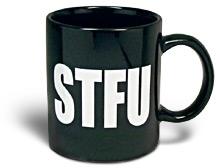 1968 Ford Mustang - Product-style photo of a black ceramic coffee mug with a handle on the right, printed with large white block letters spelling "STFU," shot…