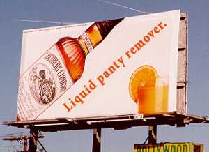 1968 Ford Mustang - Billboard advertising Sherry's Cordial with text 'Liquid panty remover.' and an orange slice.