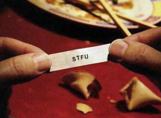 1968 Ford Mustang - Fortune cookie paper with the text STFU is held between two fingers.