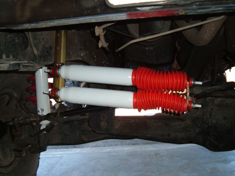 1989 Ford Bronco - Undercarriage view of a vehicle's suspension system with dual shock absorbers.