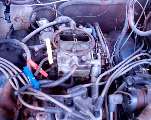 1978 Ford Bronco - Engine bay detail showing carburetor and wiring, with clothespins on a hose.