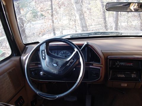1989 Ford Bronco - Interior view of a 1989 Ford Bronco, its tan dashboard and steering wheel.