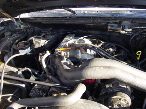 1989 Ford Bronco - A close-up view of the engine compartment, showing various mechanical parts and wiring.