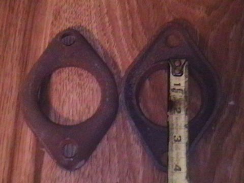 1986 Ford Bronco - Two exhaust flange gaskets are shown with a tape measure indicating their size.