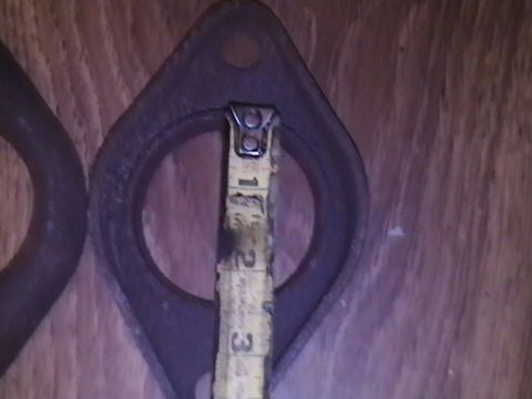1986 Ford Bronco - A tape measure is used to measure the opening of an exhaust flange.