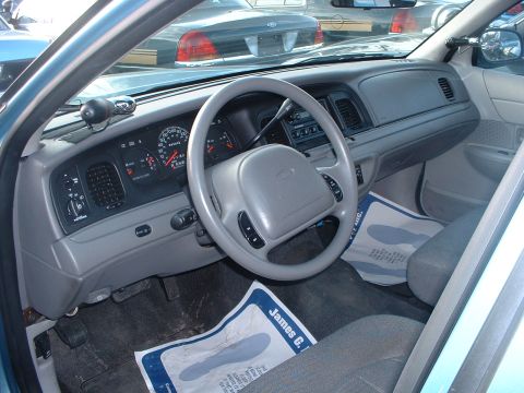 1999 Ford Crown Victoria - Interior of a 1998 Ford Crown Victoria, with another similar vehicle visible outside.