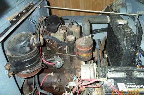 1954 Jeep Wrangler - Close-up view of the engine compartment, highlighting various mechanical components and wiring.