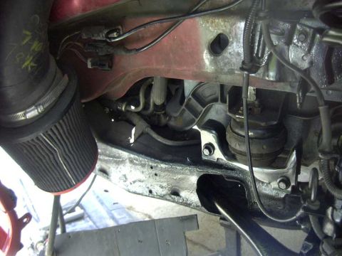 1997 Ford Taurus - Close-up of engine bay components, including an aftermarket air intake and various hoses and mounts.