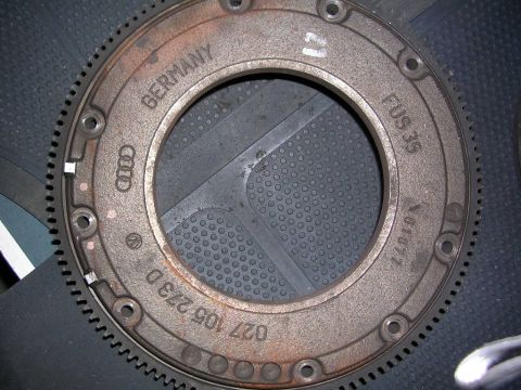 2003 Chevrolet Monte Carlo - A close-up view of a metal automotive part with various markings and gear teeth.