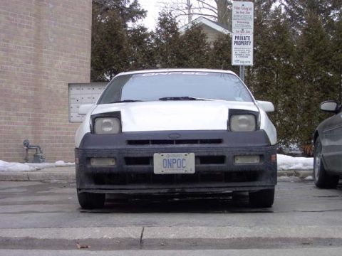 1989 Ford Probe - Front view of a white 1989 Ford Probe with a black bumper and a license plate reading ONPOC.