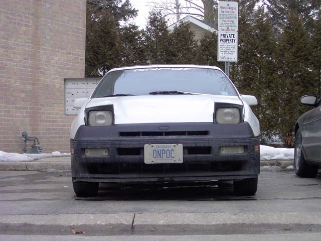 White 1989 Ford Probe front view, black bumper, license plate ONPOC, parked next to a dark car