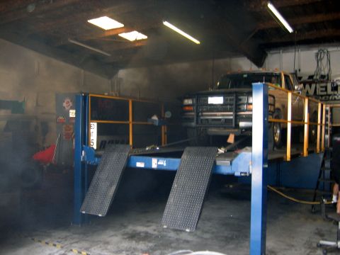 2000 Ford Crown Victoria - Truck on a dynamometer in a workshop. The grille indicates it is likely a 1992 Ford F-Series.
