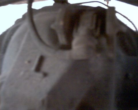 1990 Ford Bronco - This image shows a close-up view of a vehicle's undercarriage component, with no clear identifying features visible.