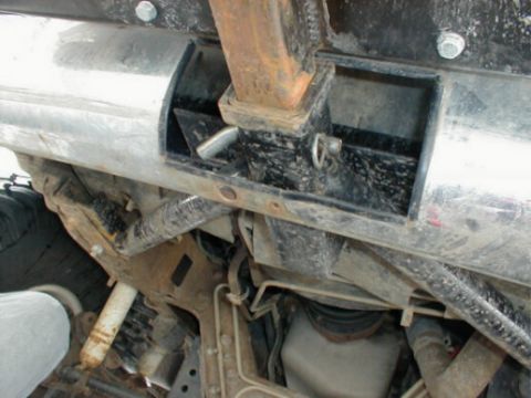 1995 Ford Bronco - Undercarriage detail of a vehicle, focusing on the hitch receiver and related parts.