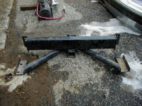 1995 Ford Bronco - A black trailer hitch is shown on a gravel surface with a portion of a vehicle visible in the background.
