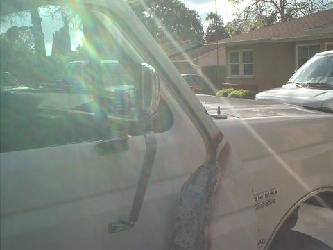1990 Ford Bronco - trying to hold the new door in place and take a decent picture of how it will look....not sure I got it yet.