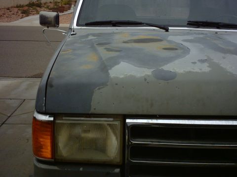 1990 Ford Bronco - Front view of a 1990 Ford Bronco with significant paint damage on the hood.