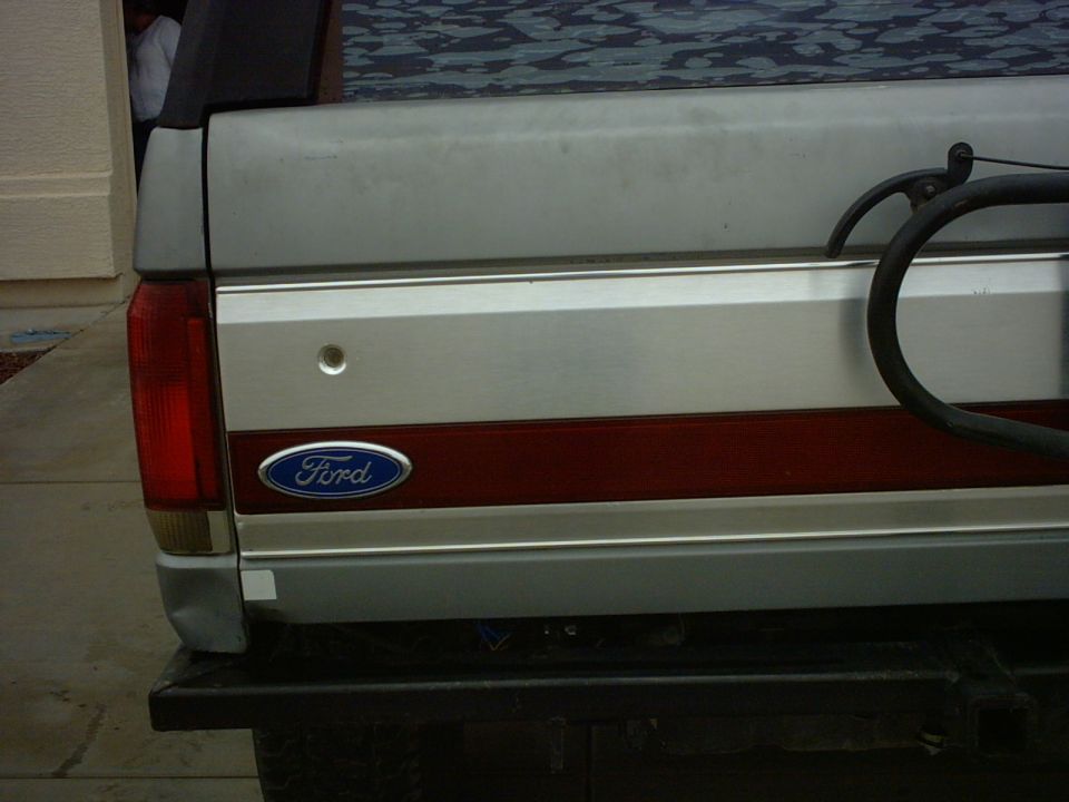 1990 Ford Bronco rear tailgate with Ford oval badge and red stripe detail