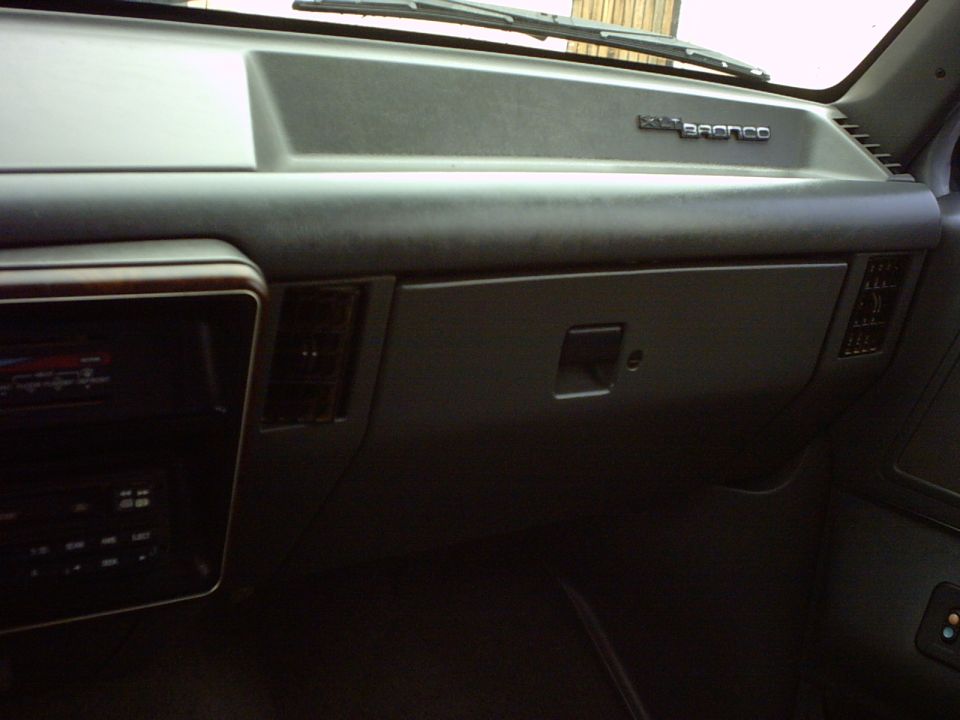 Dashboard with "Bronco" badge, wood trim, and air vents