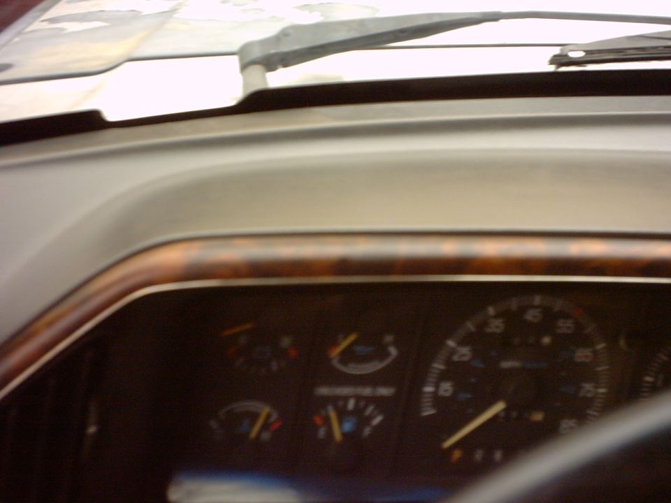 1990 Ford Bronco interior dashboard with wood trim and gauges