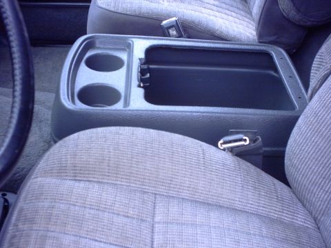1990 Ford Bronco - Close-up of a vehicle's interior, showing the center console and seats.