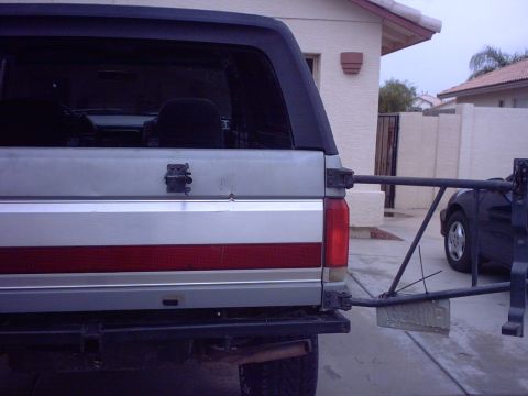 1990 Ford Bronco - Rear view of a Ford Bronco, likely from the late 1980s, showing its tailgate and a spare tire carrier.