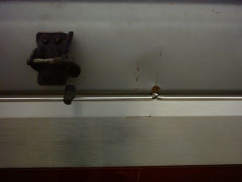 1990 Ford Bronco - A close-up view of a door latch mechanism, showing signs of rust and wear.