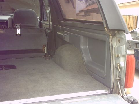 1990 Ford Bronco - The cargo area of a 1990 Ford Bronco shows its carpeted floor and side paneling.