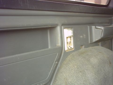 1990 Ford Bronco - Close-up view of the interior panel and a carpeted wheel well, likely from a Ford Bronco.
