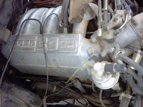 1990 Ford Bronco - Close-up of an engine intake manifold displaying '4.0L EFI' text.