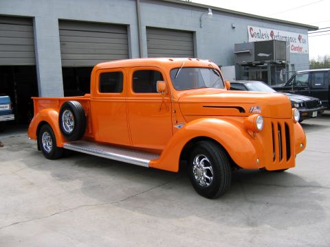 2000 Ford Crown Victoria - This vintage pickup truck, likely from the 1930s, is parked outside a performance center.