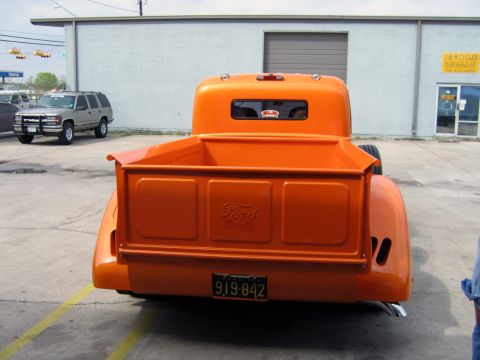 2000 Ford Crown Victoria - Rear view of an orange Ford pickup truck, the Ford script on the tailgate and a license plate.