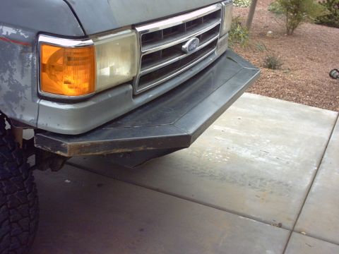1990 Ford Bronco - Front view of a gray Ford Bronco with a custom bumper and visible tire.