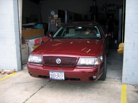 2000 Ford Crown Victoria - Front view of a red 2000 Ford Crown Victoria parked inside a garage.