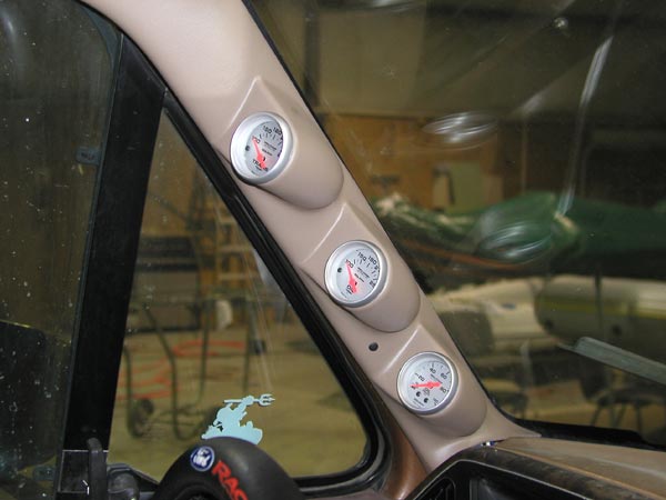 Dashboard pillar with three gauges, one showing oil pressure