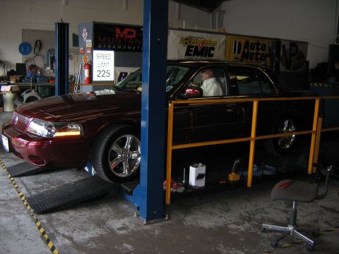 2000 Ford Crown Victoria - Ford Crown Victoria undergoing testing on a dynamometer, with a speed limit sign visible in the background.