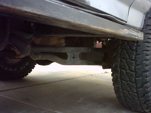 1990 Ford Bronco - The underside of a vehicle is captured, showing its tires and suspension system.