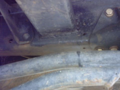 1990 Ford Bronco - Undercarriage view showing suspension components and frame structure, with SuperMotors.net watermark.