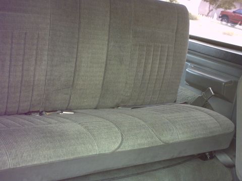 1990 Ford Bronco - Interior view of a gray fabric rear seat with a seatbelt visible.