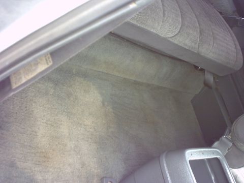 1990 Ford Bronco - Interior view of a car's floor and seat, with a label on the left side.
