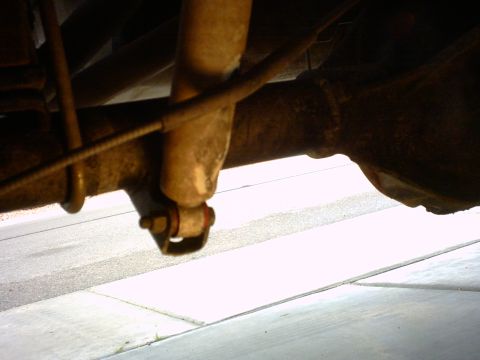 1990 Ford Bronco - Close-up of the rear suspension components, showing the shock absorber attached to the axle housing.