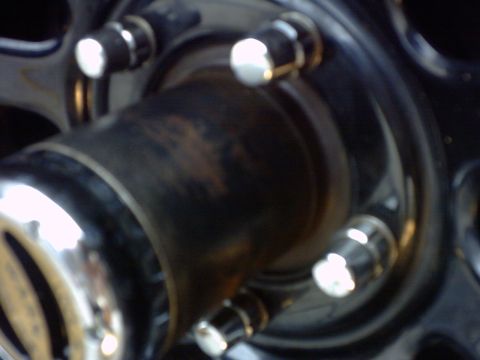 1990 Ford Bronco - A close-up view of a vehicle's wheel hub and lug nuts.