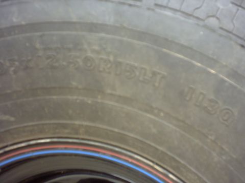 1990 Ford Bronco - Close-up of a tire showing its size designation and DOT code.