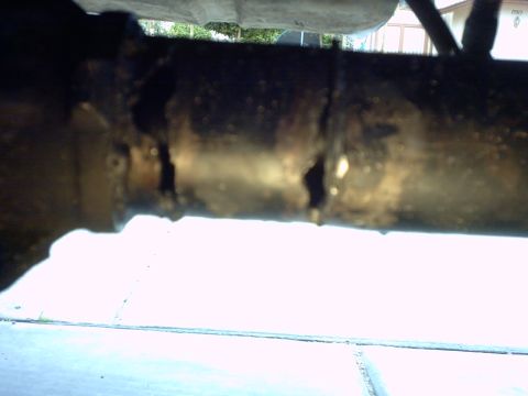 1990 Ford Bronco - Close-up of a rusted metal pipe, possibly from a vehicle's exhaust system.