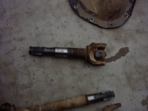 1990 Ford Bronco - Driveshaft parts shown on a concrete surface.