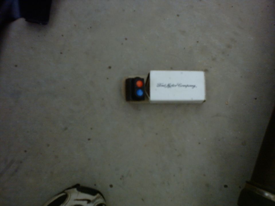 Ford Motor Company emblem on a box with red and blue lights