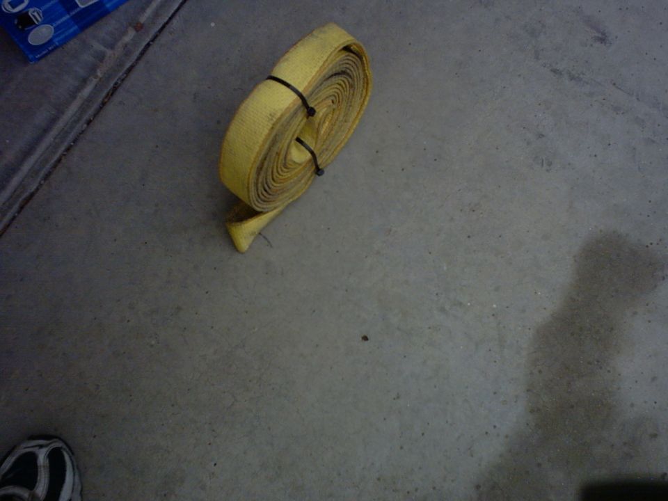 Rolled yellow tow strap on concrete floor