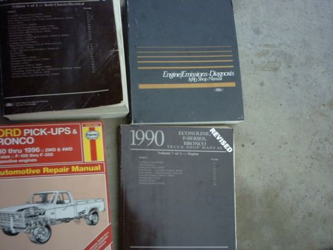 1990 Ford Bronco - Collection of Ford truck and Bronco repair manuals, including a 1990 edition.