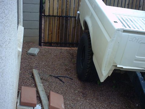 1990 Ford Bronco - The rear quarter panel of a white pickup truck is visible, with the number 3042 written on the side.