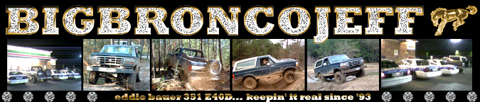 1993 Ford Bronco, dark blue, lifted, off-road tires, mud-splattered, 3/4 front view